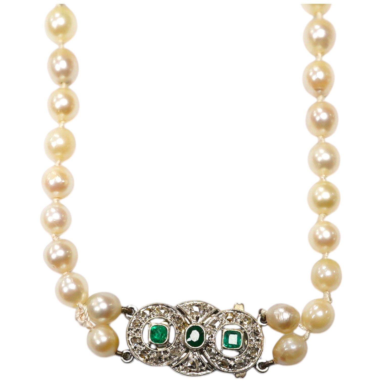 A single strand cultured pearl necklace, with and emerald and diamond cluster set white metal clasp, 76cm. Condition - fair.